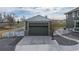 Attached two-car garage featuring a large driveway and extra space for storage at 16110 Poplar St, Brighton, CO 80602
