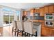 Modern kitchen featuring stainless steel appliances, an island with bar seating, and a bright breakfast nook at 16110 Poplar St, Brighton, CO 80602