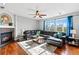 Comfortable living room with hardwood floors, a fireplace, and a large leather sectional with scenic outdoor views at 16110 Poplar St, Brighton, CO 80602