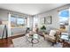 Bright living room showcasing hardwood floors, large windows with scenic views, and neutral-toned decor at 16110 Poplar St, Brighton, CO 80602
