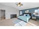 Spacious main bedroom with a blue accent wall, stylish furnishings, and large windows at 16110 Poplar St, Brighton, CO 80602