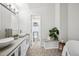 Serene bathroom featuring dual vessel sinks, designer tile flooring, and a freestanding soaking tub at 4 Mountain Ash, Littleton, CO 80127