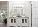 Well-lit bathroom boasts dual vessel sinks and a stylish vanity with ample counter space at 4 Mountain Ash, Littleton, CO 80127