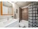 Well-lit bathroom with modern vanity, stylish mirror, and tiled shower/tub combo at 4 Mountain Ash, Littleton, CO 80127