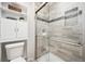 Modern bathroom with glass-enclosed shower featuring tiled walls and built-in shelving at 4 Mountain Ash, Littleton, CO 80127