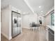 Stainless refrigerator, adjacent table, and seamless access to outdoor space define modern kitchen layout at 4 Mountain Ash, Littleton, CO 80127