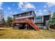 Back of the home with deck, stairs, and hot tub for ultimate relaxation at 4 Mountain Ash, Littleton, CO 80127