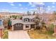 Beautiful exterior view of a home with a large driveway and mountain views in the background at 4 Mountain Ash, Littleton, CO 80127