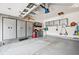 Spacious garage with ample storage cabinets, overhead racks and epoxy floor at 4 Mountain Ash, Littleton, CO 80127