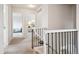 Upstairs hallway featuring decorative wrought iron banister and views into bedrooms at 4 Mountain Ash, Littleton, CO 80127