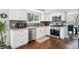 Bright kitchen featuring stainless steel appliances, granite countertops, and modern white cabinets at 4 Mountain Ash, Littleton, CO 80127