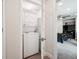 Convenient stacked washer and dryer inside with bedroom visible nearby at 4 Mountain Ash, Littleton, CO 80127