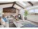 Cozy living room featuring a brick fireplace, wood beams, skylights, and natural light at 4 Mountain Ash, Littleton, CO 80127