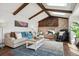 Inviting living room with a fireplace, exposed wood beams, skylights, and a comfortable seating area at 4 Mountain Ash, Littleton, CO 80127