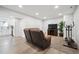 Basement Living Room with a leather sofa, TV, exercise machine and wood-look flooring at 4 Mountain Ash, Littleton, CO 80127