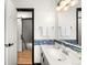 Bathroom with a white vanity, decorative backsplash, and a view into the hall at 11210 Parliament Way, Parker, CO 80138