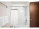 Bathroom with a shower and tub combination and a white shower curtain at 11210 Parliament Way, Parker, CO 80138