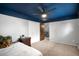 Bedroom with a navy painted ceiling, plush carpet, and a comfortable bed at 11210 Parliament Way, Parker, CO 80138