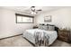 Charming bedroom with a ceiling fan, window, and decorative pillows at 11210 Parliament Way, Parker, CO 80138