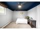 Bedroom with a navy painted ceiling, plush carpet, and a warm, inviting atmosphere at 11210 Parliament Way, Parker, CO 80138