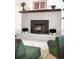 Close up of brick fireplace with wood burning stove and modern decor at 11210 Parliament Way, Parker, CO 80138