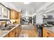 Spacious kitchen with stainless steel appliances and granite countertops extending into adjoining living space at 11210 Parliament Way, Parker, CO 80138