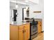 A kitchen island with wooden cabinets, stainless steel appliances, and granite countertops at 11210 Parliament Way, Parker, CO 80138