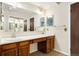 Bright bathroom featuring a double sink vanity, large mirror, and warm, inviting lighting at 8040 S Culebra Peak, Littleton, CO 80127