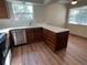 Well-lit kitchen with laminate floors, stainless steel dishwasher, and white countertops at 8040 S Culebra Peak, Littleton, CO 80127