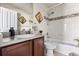 Well-lit bathroom features a tub with shower, decorative tiling, and vanity with good storage at 1114 Lasnik St, Erie, CO 80516