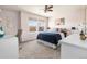 Cozy bedroom featuring carpet, a ceiling fan, two windows, and a work desk at 1114 Lasnik St, Erie, CO 80516