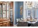 Dining area featuring modern lighting fixtures, stylish decor, and an adjacent hutch for storage at 1114 Lasnik St, Erie, CO 80516