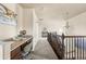 Upstairs hallway featuring a built-in desk, overhead lighting, and wooden banister at 1114 Lasnik St, Erie, CO 80516