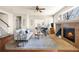 Bright living room with fireplace, hardwood floors, and staircase leading to the second floor at 1114 Lasnik St, Erie, CO 80516