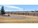 Backyard featuring a wooden fence, a small tree, decorative rocks and a view of the mountains in the distance at 16525 Sanford St, Mead, CO 80542