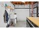 Unfinished basement space with concrete floors, white walls, exposed wood ceiling and utility sink at 16525 Sanford St, Mead, CO 80542