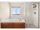 A bathroom with soaking tub, view from the window, and a glass-enclosed shower with tiled walls at 16525 Sanford St, Mead, CO 80542