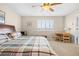 Bright bedroom with a comfortable bed, a wooden desk, and a window with white blinds, offering a relaxed atmosphere at 16525 Sanford St, Mead, CO 80542