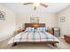 Cozy bedroom features a comfortable bed with a plaid comforter, ceiling fan, and matching nightstands at 16525 Sanford St, Mead, CO 80542