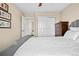 Bedroom with a gray bed and white bedding, closet, and white trim at 16525 Sanford St, Mead, CO 80542