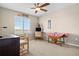 Bright bedroom featuring neutral walls, carpeted floors, ceiling fan, and a large window with scenic views at 16525 Sanford St, Mead, CO 80542