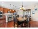 The dining area has a dark wooden table, dark leather chairs, and it flows into the kitchen with stainless steel appliances at 16525 Sanford St, Mead, CO 80542