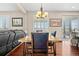 Elegant dining area featuring a wooden table set, chandelier, and sliding doors at 16525 Sanford St, Mead, CO 80542