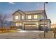 Charming two-story home featuring a three-car garage, covered porch, and beautiful exterior lighting at 16525 Sanford St, Mead, CO 80542