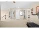 Spacious hallway featuring neutral walls, carpeted floors, white trim and doors, and artwork on the walls at 16525 Sanford St, Mead, CO 80542