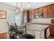 Spacious kitchen island with bar seating, granite countertops, and ample natural light from sliding door at 16525 Sanford St, Mead, CO 80542