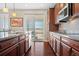 A modern kitchen with stainless steel appliances, granite countertops, and a sliding door that leads to the backyard at 16525 Sanford St, Mead, CO 80542