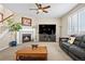 Living room with a fireplace, large TV and a comfortable gray sofa at 16525 Sanford St, Mead, CO 80542