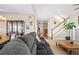 Comfortable living room area with seamless transition to dining room and view of the staircase at 16525 Sanford St, Mead, CO 80542