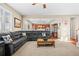 Open-concept living room leading to a kitchen features a large sectional and natural light at 16525 Sanford St, Mead, CO 80542